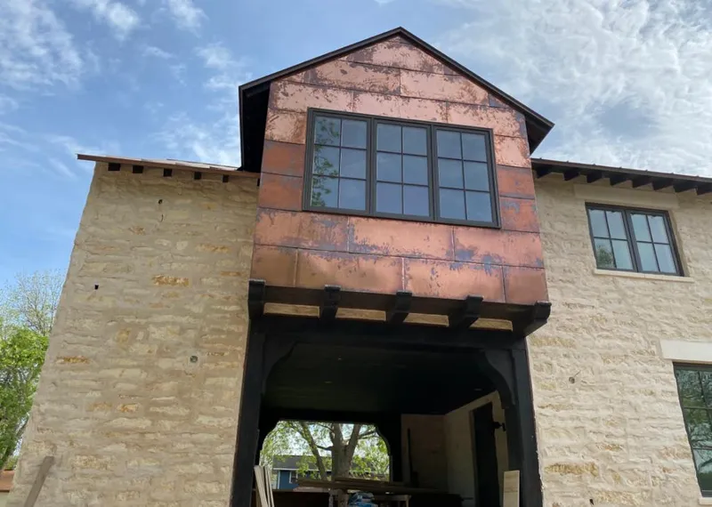 Copper metal panel facade on a stone building for Roof Repair in Visalia